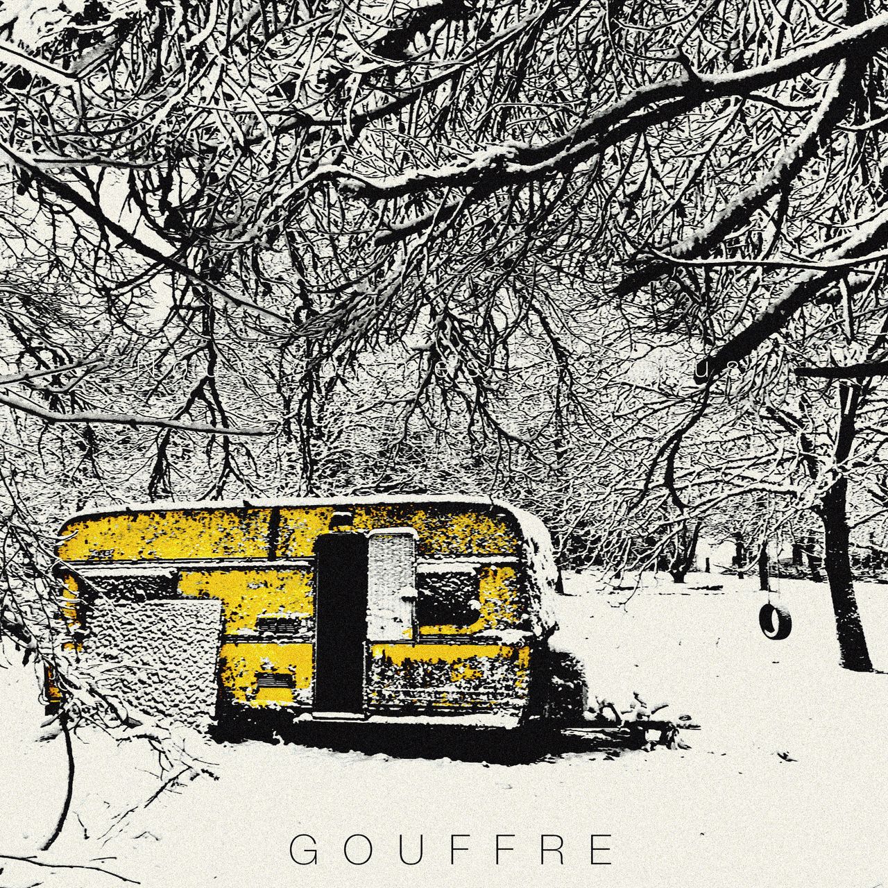 forest covered in snow, we see a yellow trailer and a tyre hanged on a branch so kids can swing.